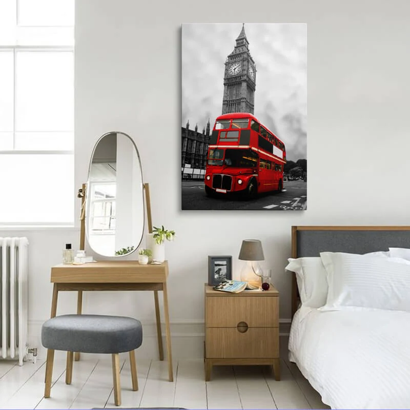 Red London Bus canvas hung in a bedroom above a bedside table