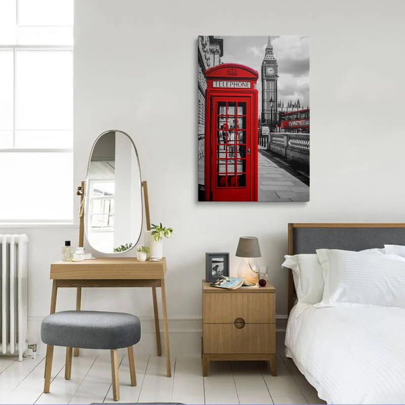 Red London Telephone Box canvas hung in a bedroom above a bedside table