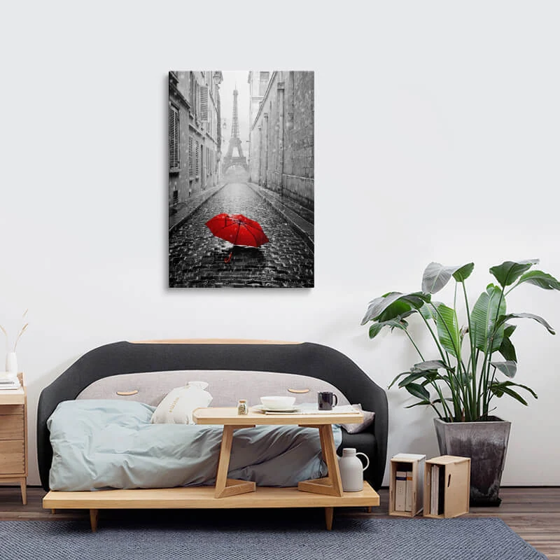 Red Umbrella Eiffel Tower canvas hung above a sofa in a lounge