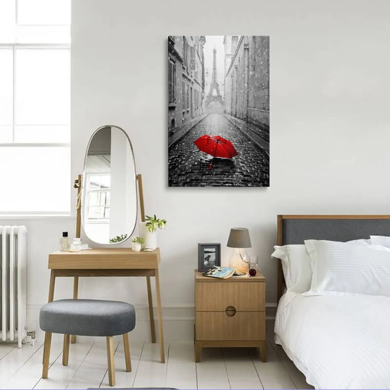 Red Umbrella Eiffel Tower canvas hung in a bedroom above a bedside table