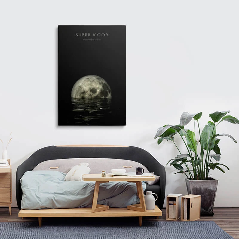 Super Moon On The Water canvas hung above a sofa in a lounge