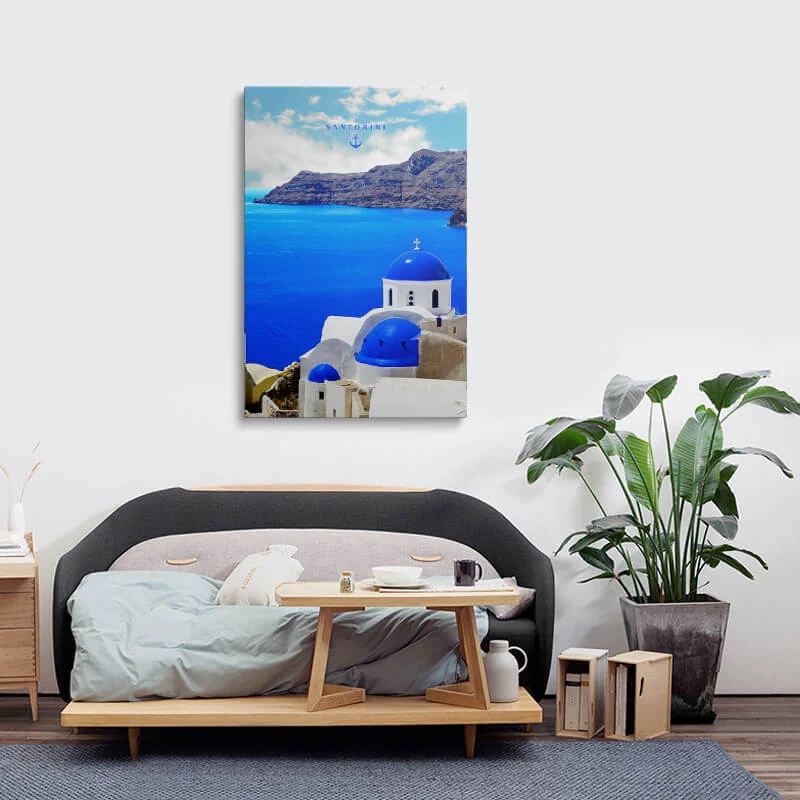 Three Bells Of Fira canvas hung in a bedroom above a bedside table