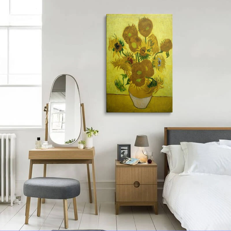 Vincent Van Gogh Sunflowers canvas hung in a bedroom above a bedside table