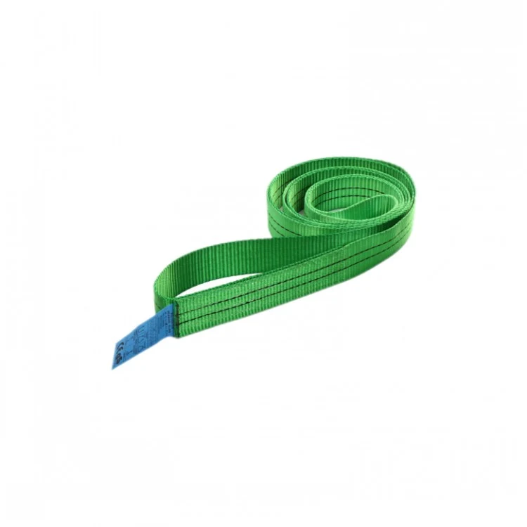 Coiled green polyester webbing lifting sling with a small blue tag, isolated on a white background