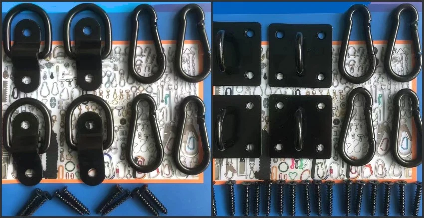 Assorted black metal hardware including eye hooks, D-rings, mounting plates, carabiners, and screws