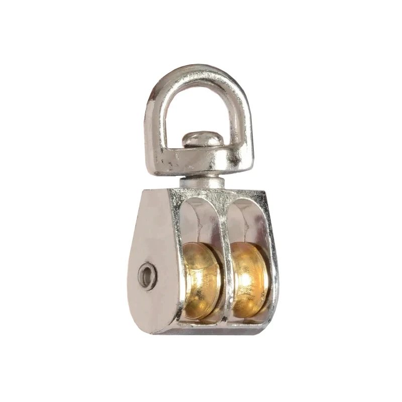 Polished metal double-sheave pulley block with brass rollers and swivel eye ring on white background