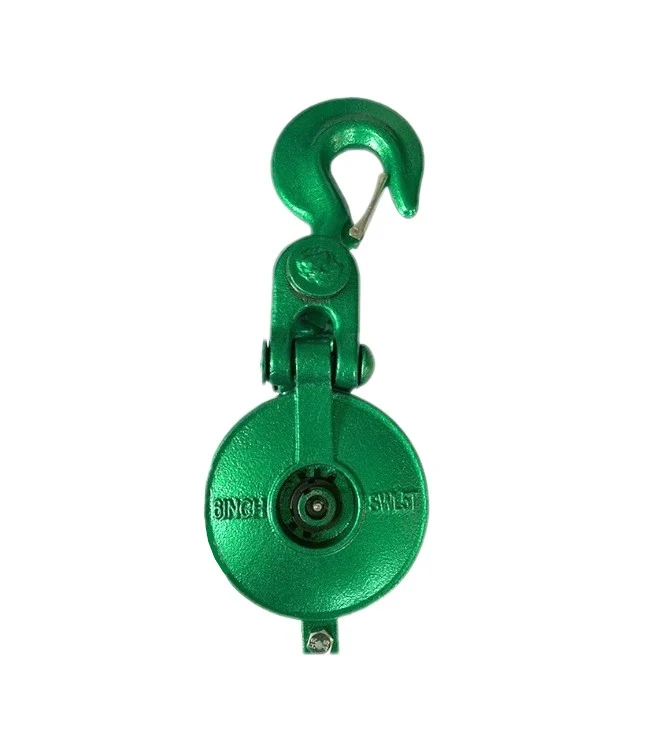 Green painted swivel hook pulley block with a safety latch on a white background