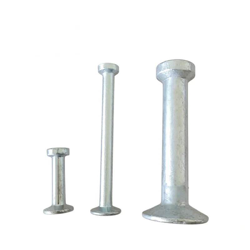 Three galvanized steel spherical head lifting anchors of varying sizes standing upright against a white background