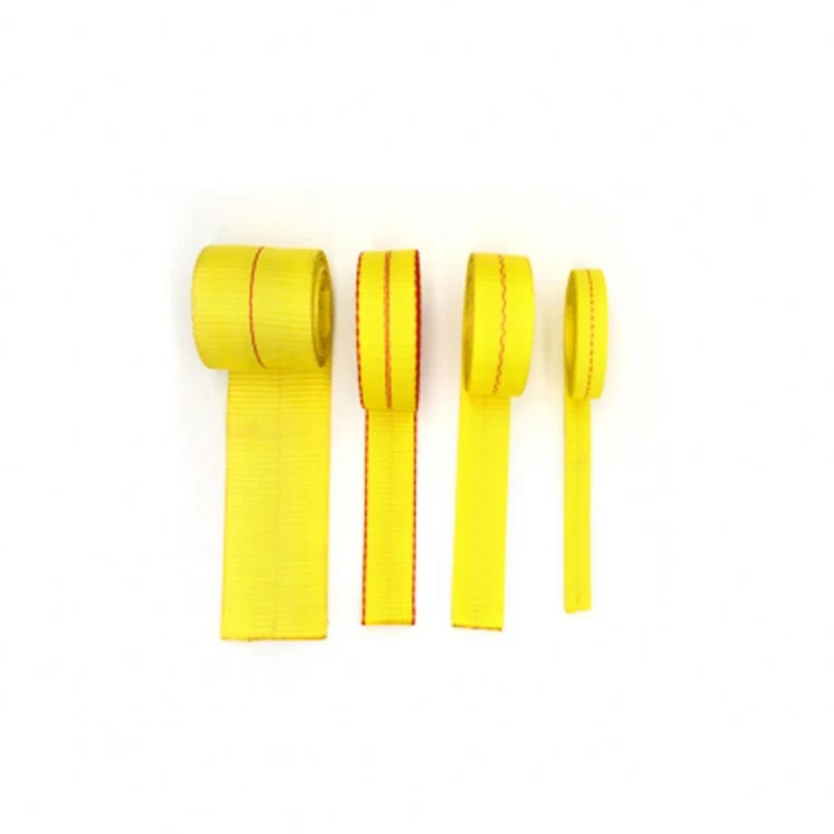 four rolls of yellow webbing with red stitching on a white background