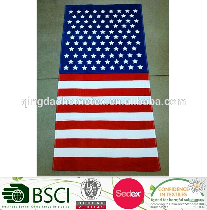 American flag pattern beach towel with white stars on blue field and red-and-white stripes, laid flat on a tiled floor