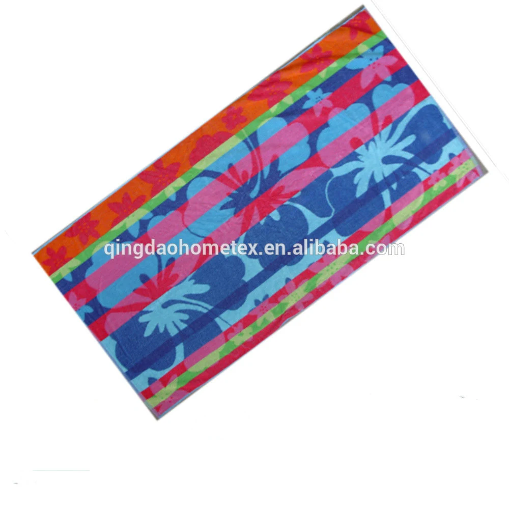 Colorful beach towel with hibiscus floral print in blue, pink, orange and green stripes on white background