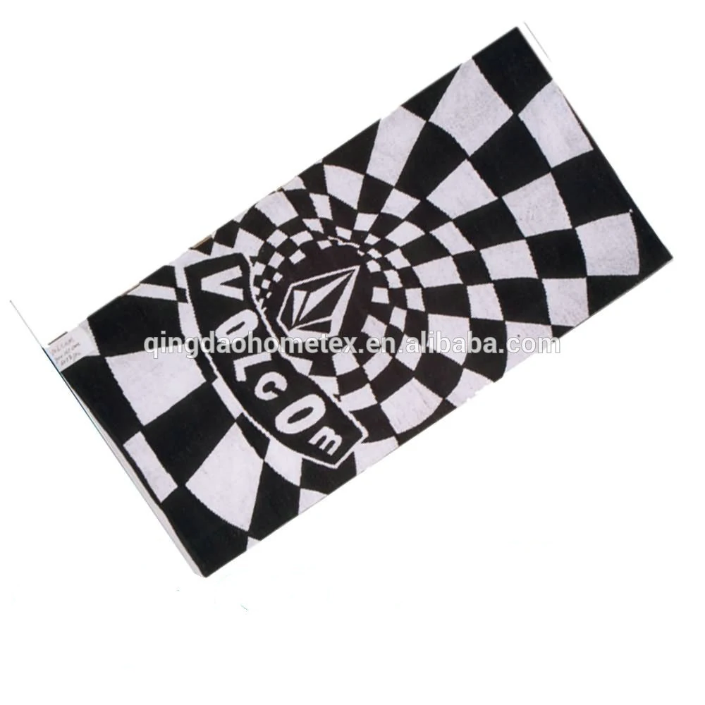 Black and white warped checkerboard towel with printed VOLCOM stone logo, tilted on white background