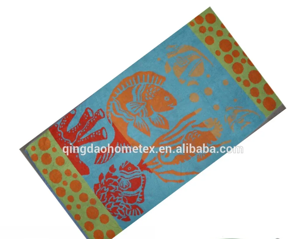 Blue beach towel with orange fish and coral print tilted diagonally, BSCI and Oeko-Tex certification logos overlaid below