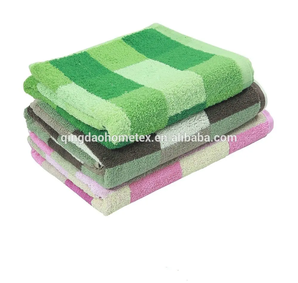 Stack of folded checkered towels in green, brown, and pink on a white background