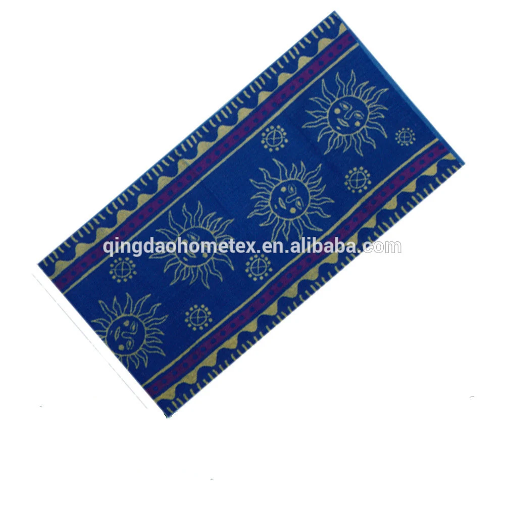 Blue towel with sun and moon prints and patterned borders, tilted diagonally on a white background