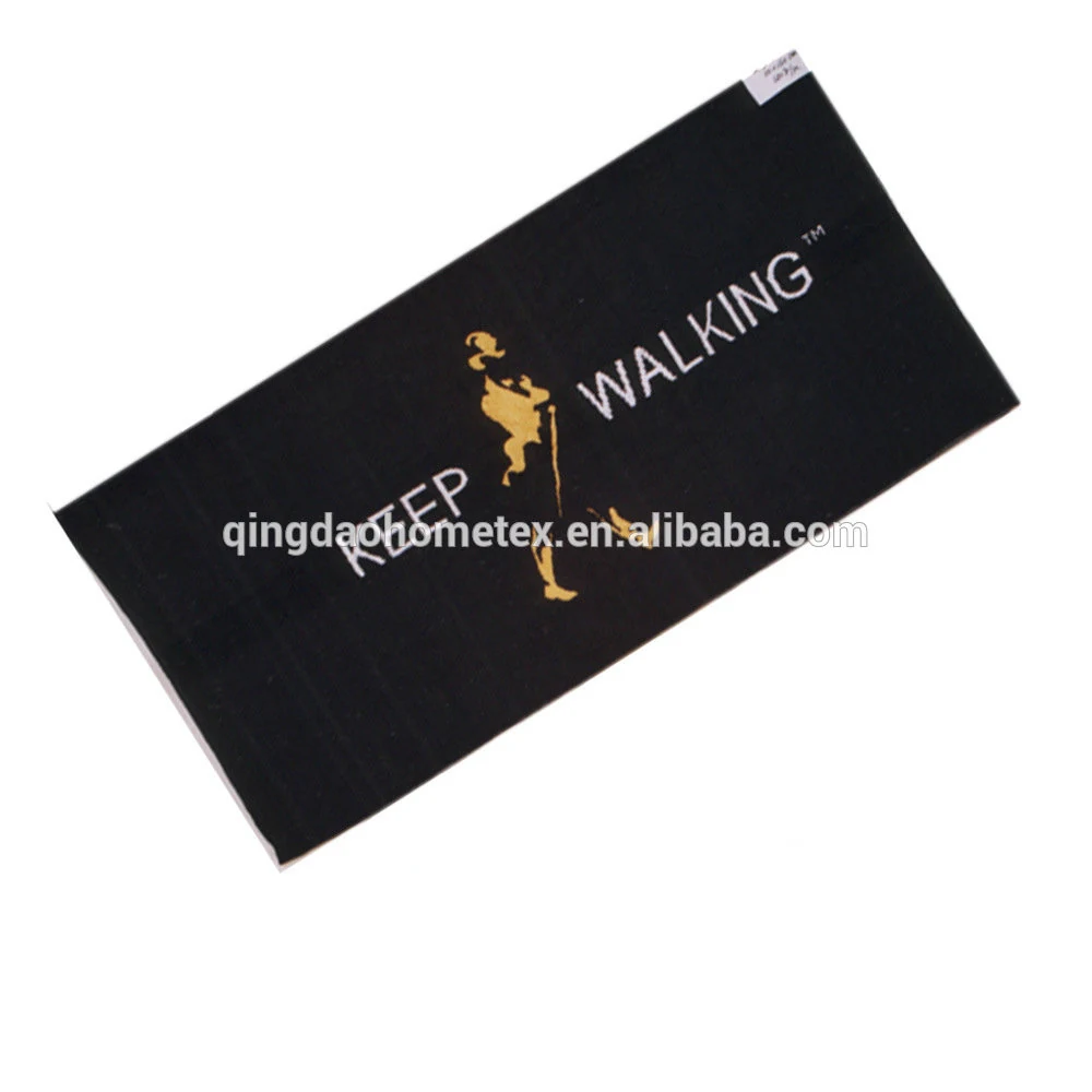 A black rectangular doormat with a gold silhouette of a hiker and the text KEEP WALKING.