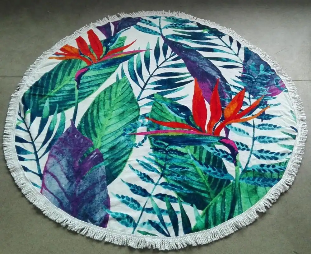 150 cm diameter round 100% cotton beach towel with a green leaves pattern printed on the surface and tassels on the edge, laid flat