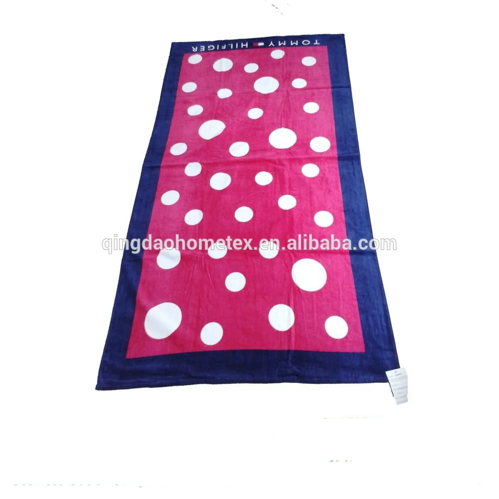 Pink and navy blue towel with large white polka dots.