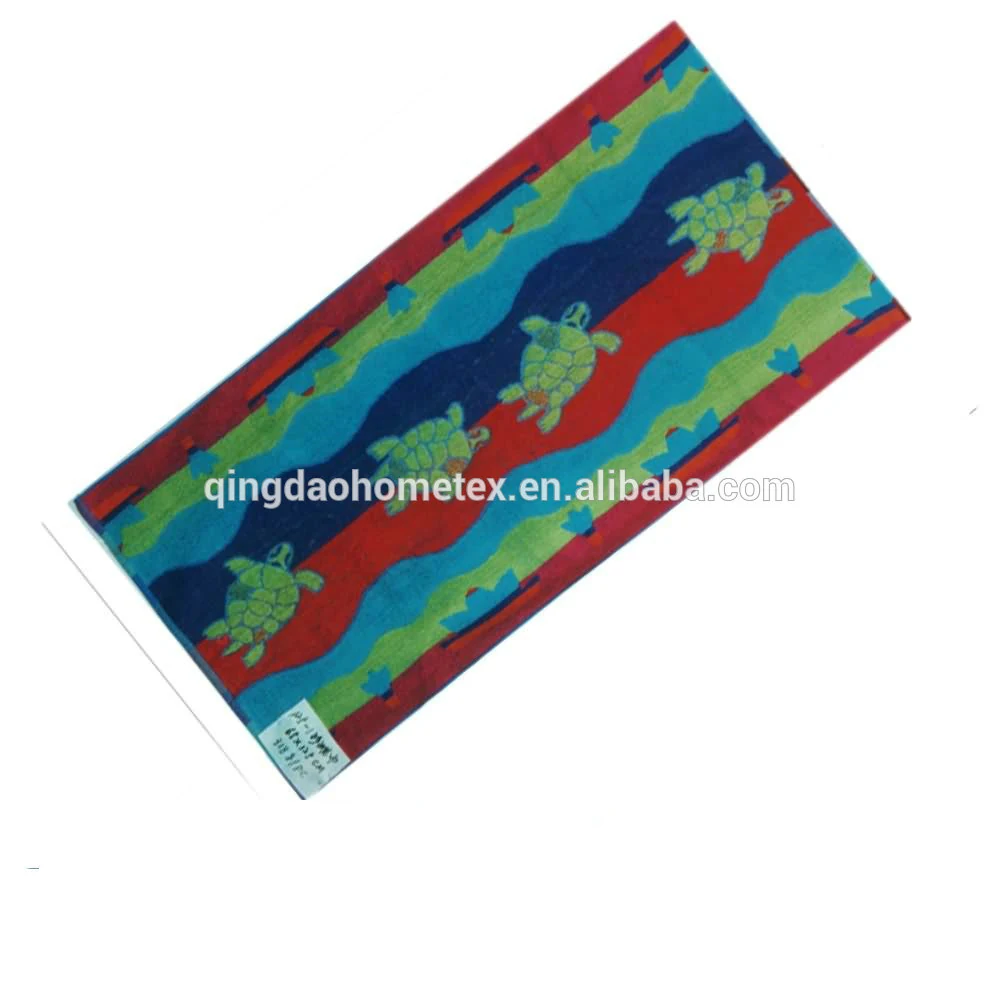 Colorful beach towel with turtle and wavy stripe pattern in blue, green, and red, on white background