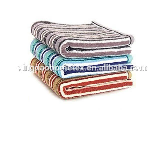 Stack of four folded striped towels in grey, teal, blue and red on a white background