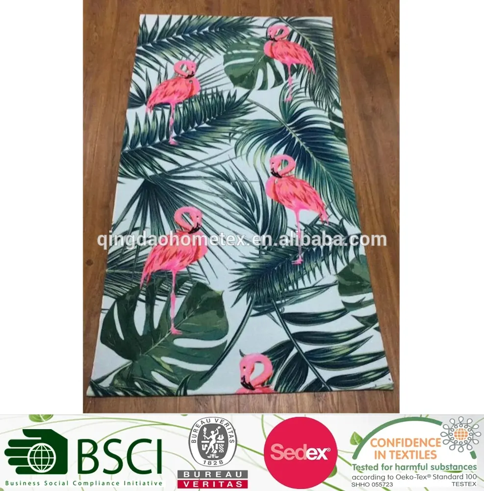 Flamingo and tropical leaf patterned fabric on a wooden floor with certification logos at the bottom.