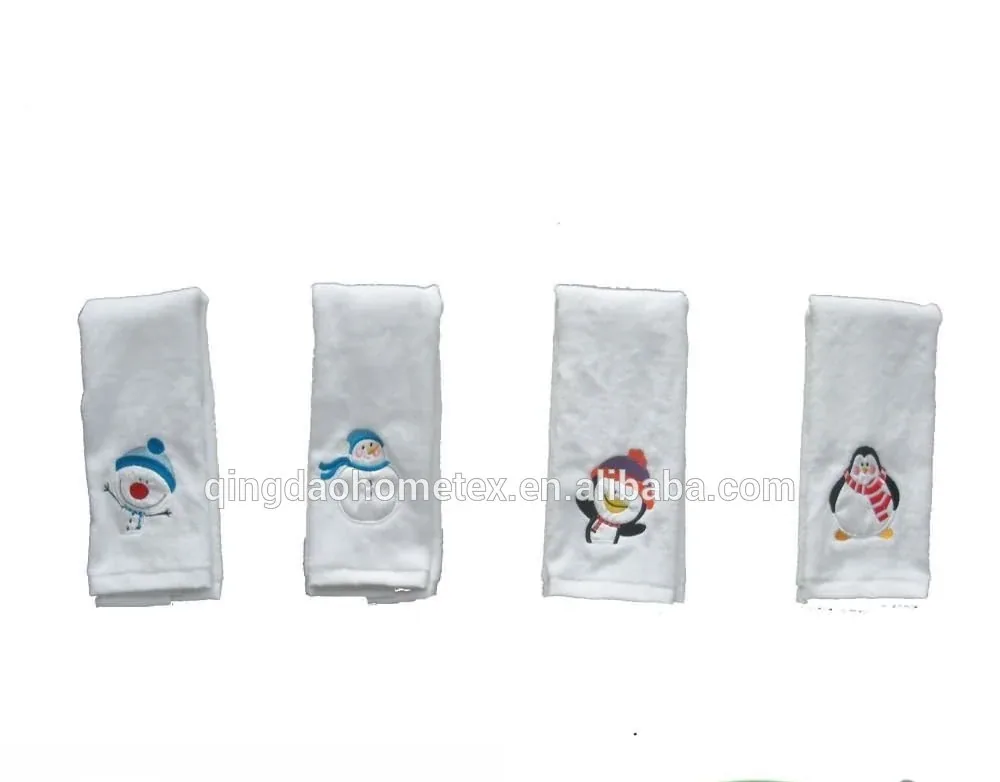 Four white towels with embroidered snowman and penguin winter designs displayed on a white background