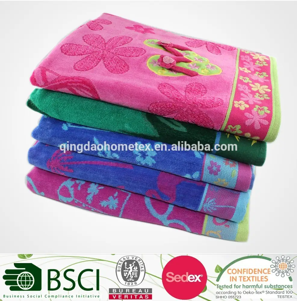 Stacked pink, green, blue, and purple folded towels with floral jacquard patterns.