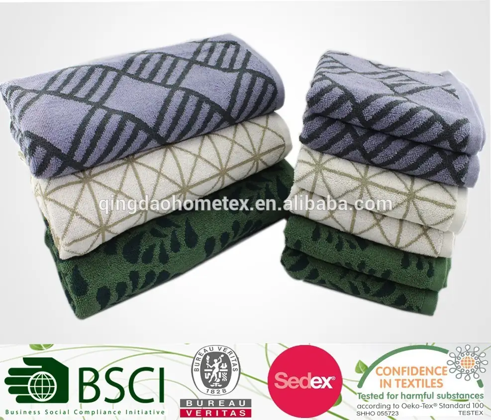 Two stacks of folded patterned towels in blue, cream, and green on a white background