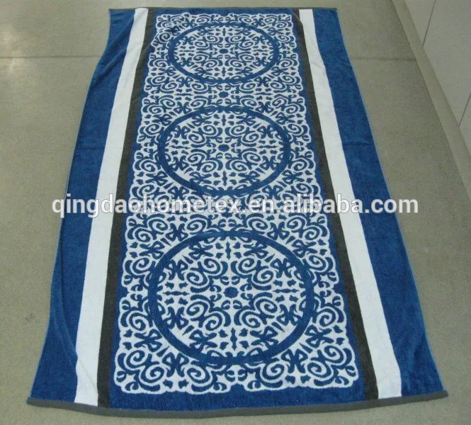 Blue and white patterned towel lying flat on a floor