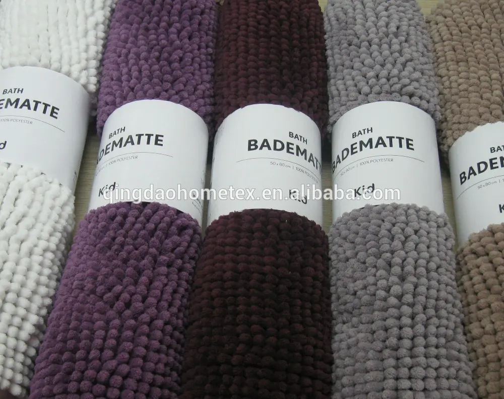 Five chenille bath mats in white, purple, brown, grey, and beige with paper labels.
