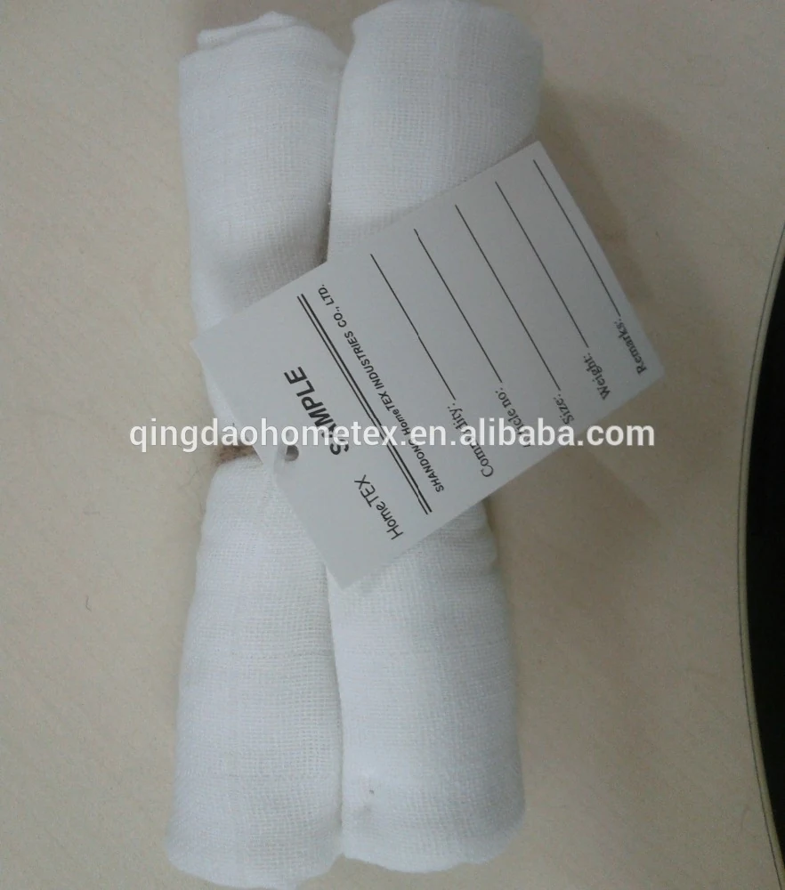 Two rolls of white gauze bandage with a product label, placed on a light surface.