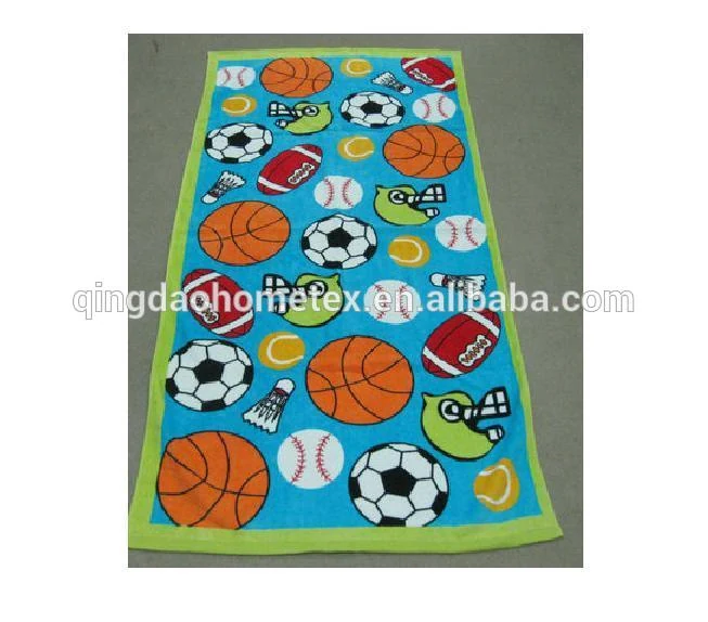 Printed beach towel with green border featuring sports ball patterns including basketballs, soccer balls, and footballs on blue background