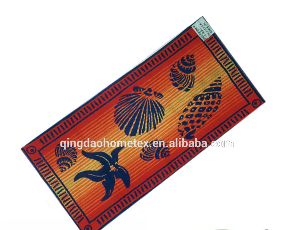 Orange and navy printed beach towel with seashell and starfish designs, shown diagonally on white background