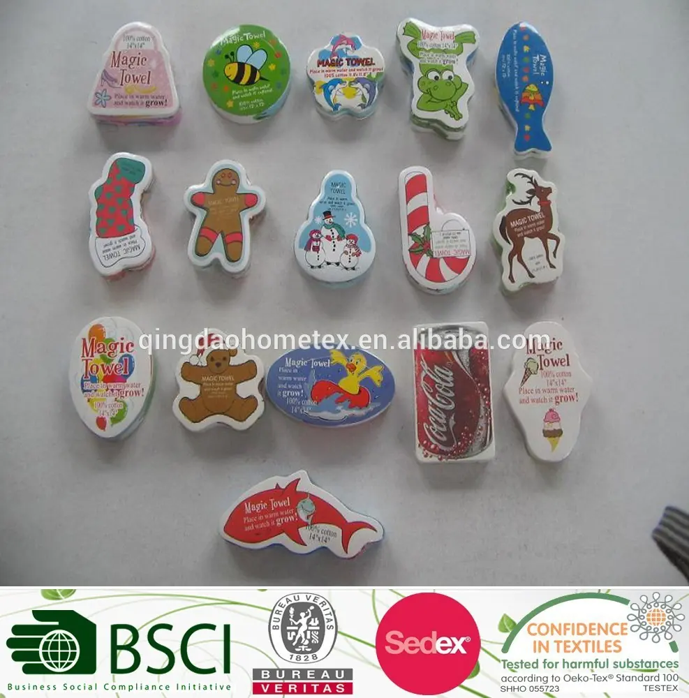 Assorted compressed towels in novelty shapes, including gingerbread man, candy cane, fish, and bear, on a white surface