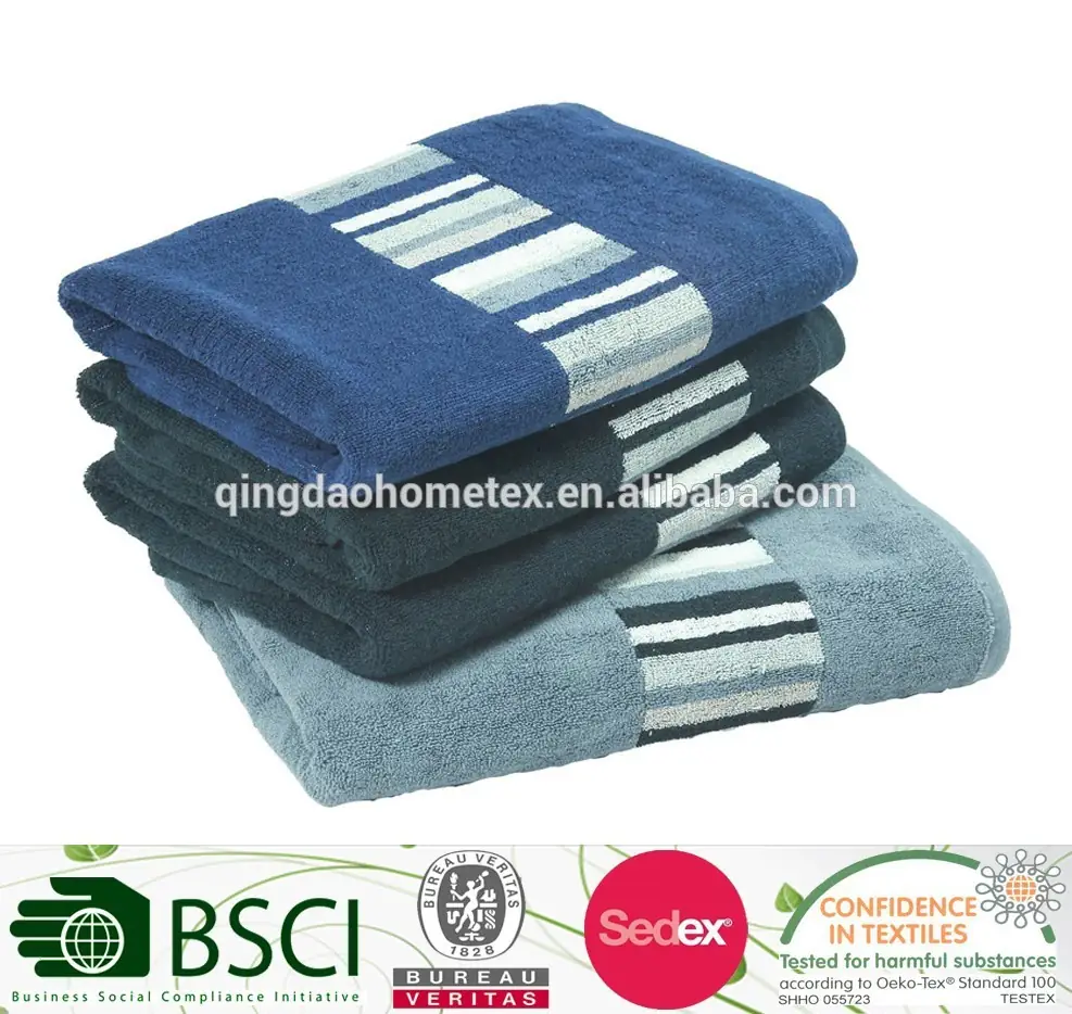 Stack of folded blue, dark grey, and light blue towels with striped borders on a white background