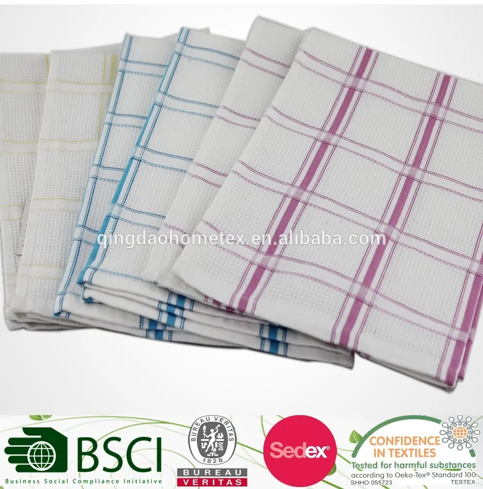 Stack of woven check-pattern kitchen towels in yellow, blue, and purple, with certification logos overlaid at the bottom