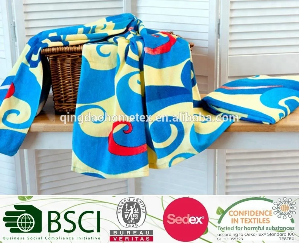 Blue and yellow printed towel fabric draped over a wicker basket on a wooden surface