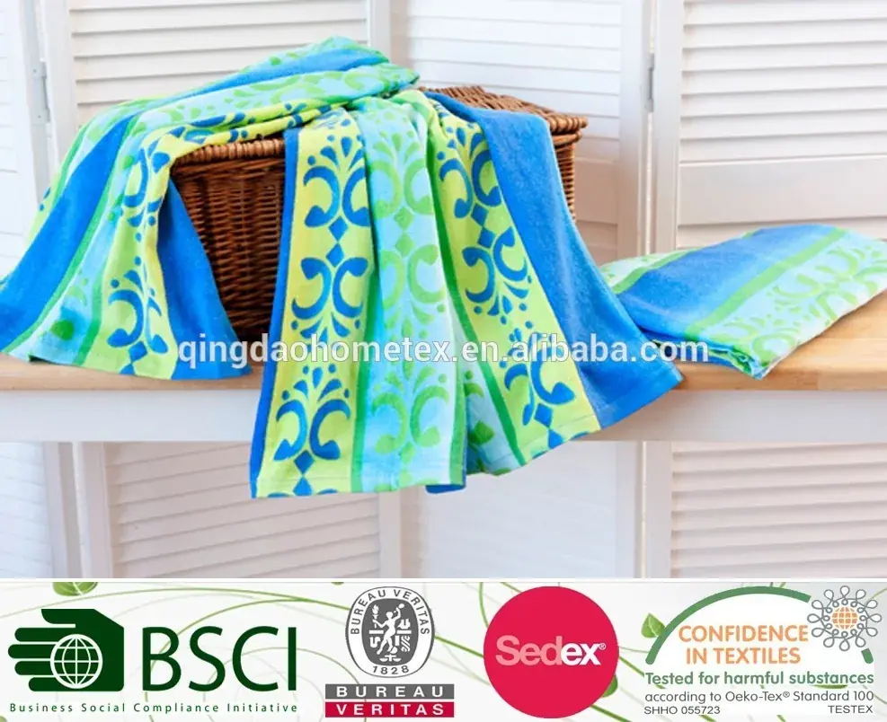 Colorful blue and green patterned towels draped over a wicker basket on a wooden shelf