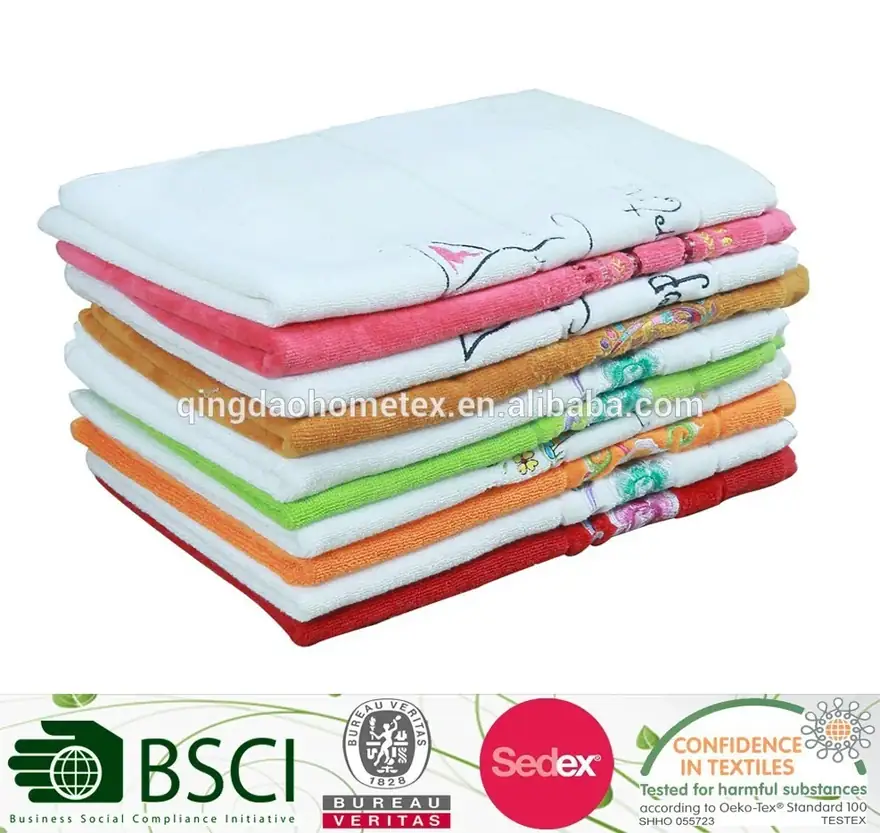 Stack of folded towels in white, pink, orange, green, and red with embroidered designs on a white background