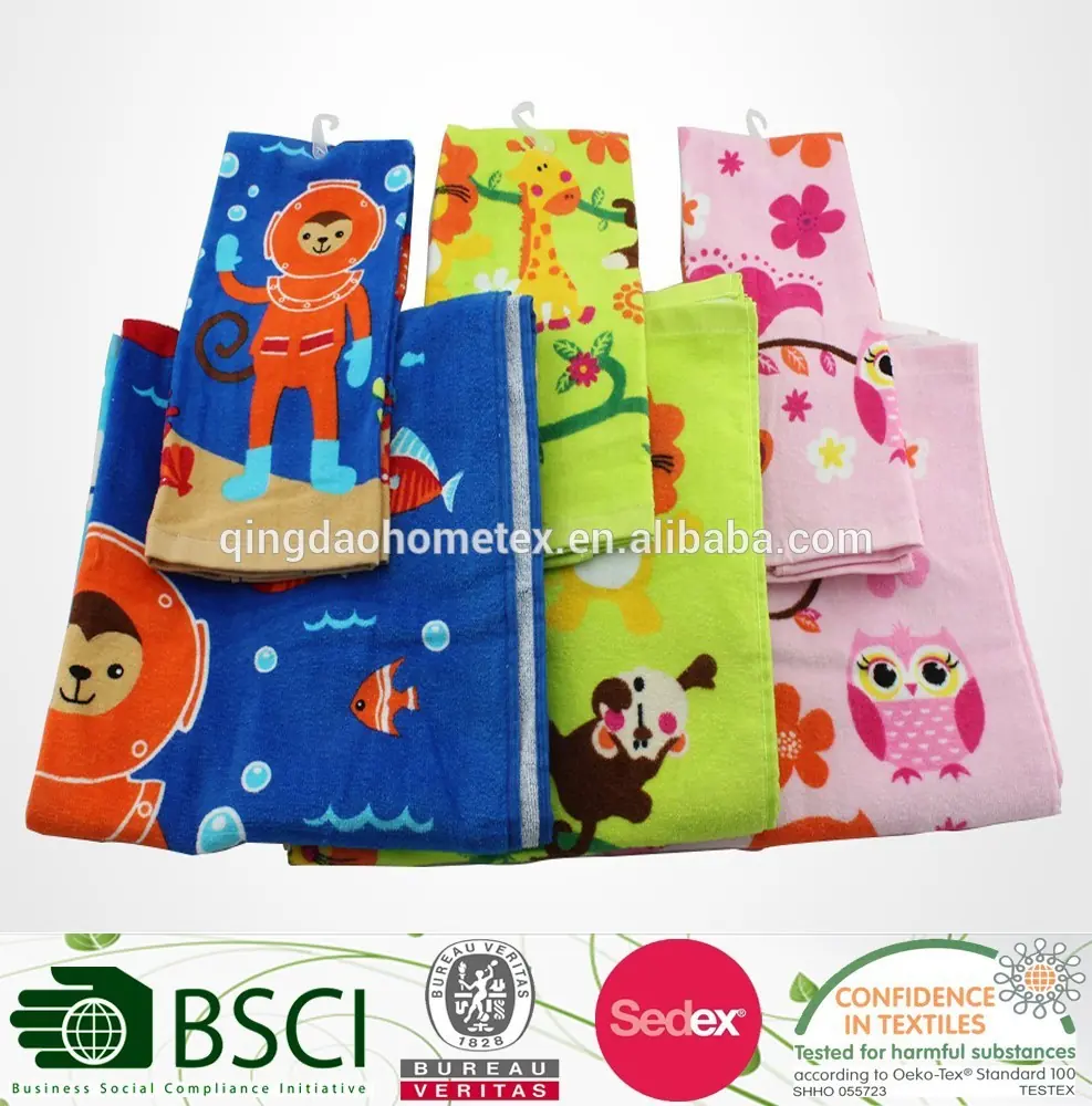 Folded children's towels with colorful cartoon prints including monkey, giraffe, and owl designs