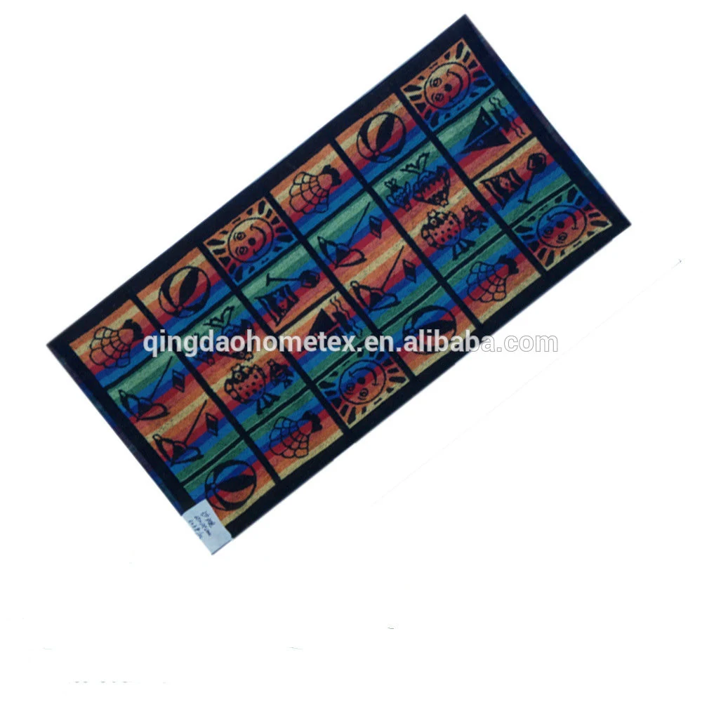 Colorful striped beach towel with beach-themed novelty prints laid diagonally on a white background