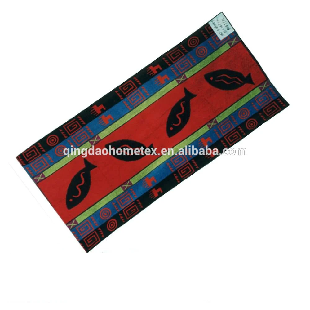 Rectangular woven rug with red center panel, black fish motifs, and geometric blue, green, and red borders on a white background