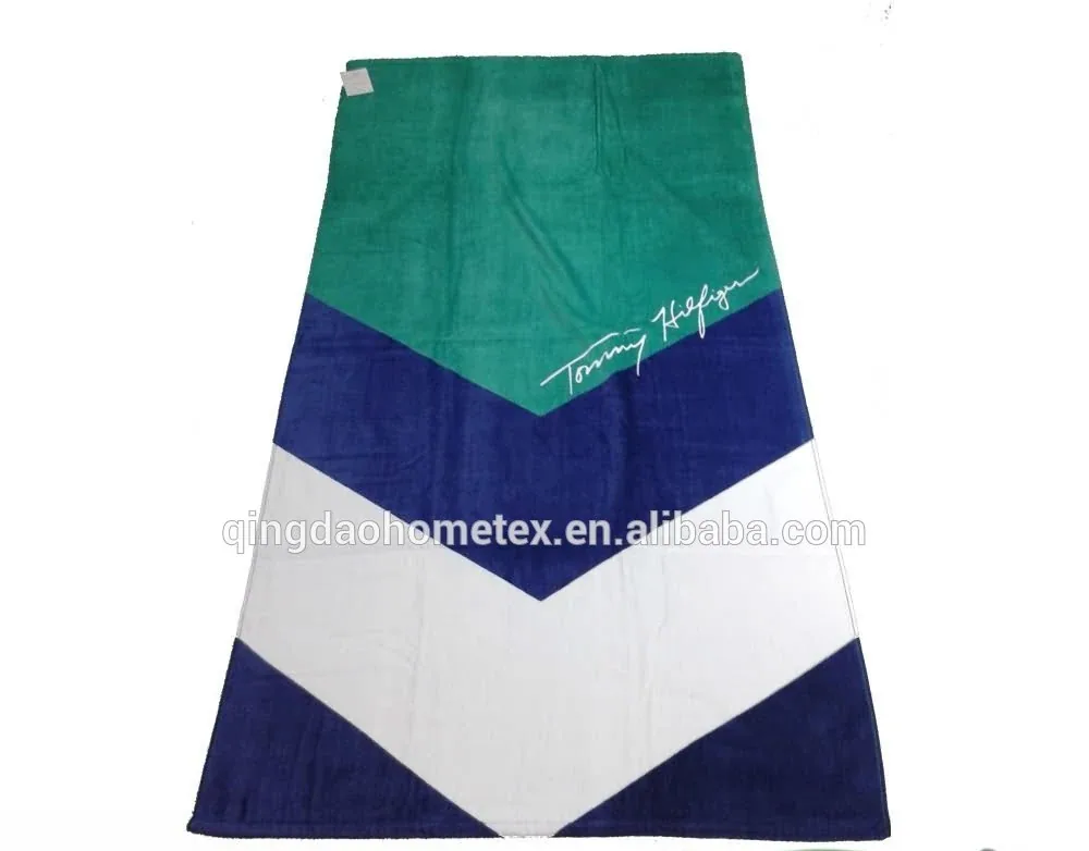 Beach towel with green, navy, and white chevron panels and a script logo, shown flat with BSCI and Oeko-Tex badges below