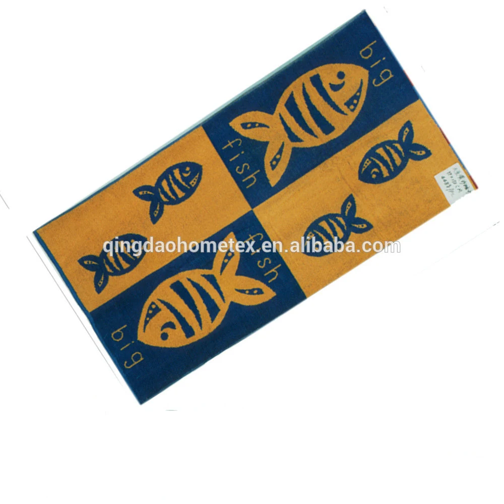 Beach towel with orange and navy fish-print panels, rotated diagonally on white background