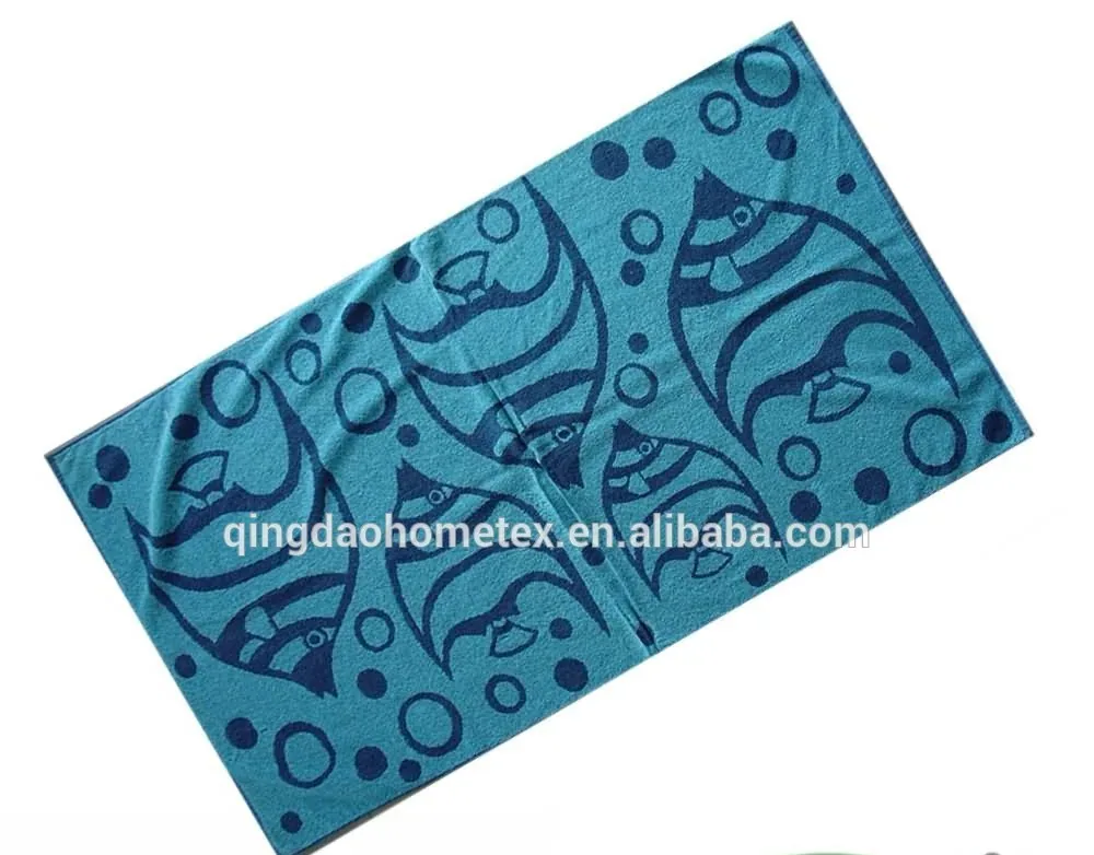 Teal beach towel with dark blue fish and bubble print, shown diagonally with BSCI and Confidence in Textiles certification logos below