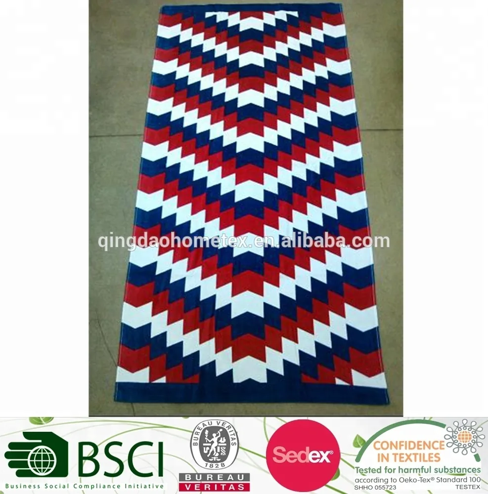 Red, white and blue chevron-patterned beach towel laid flat on a tiled floor