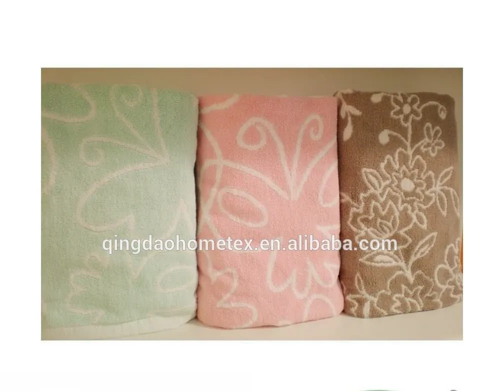Three folded towels in green, pink, and brown with floral patterns, shown with BSCI and Confidence in Textiles certification logos