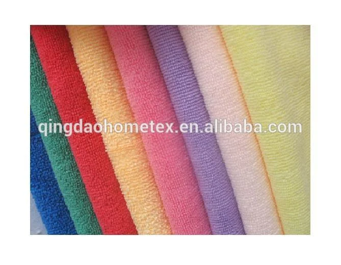 Rolled towels in blue, green, red, orange, pink, purple and yellow arranged side by side