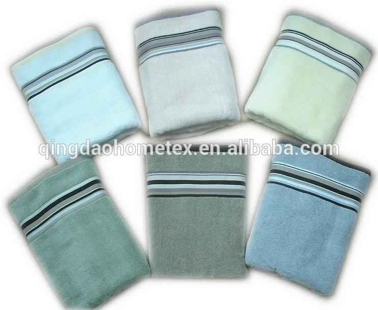 Six folded towels in pastel blue, grey, green, and teal with striped borders on a white background
