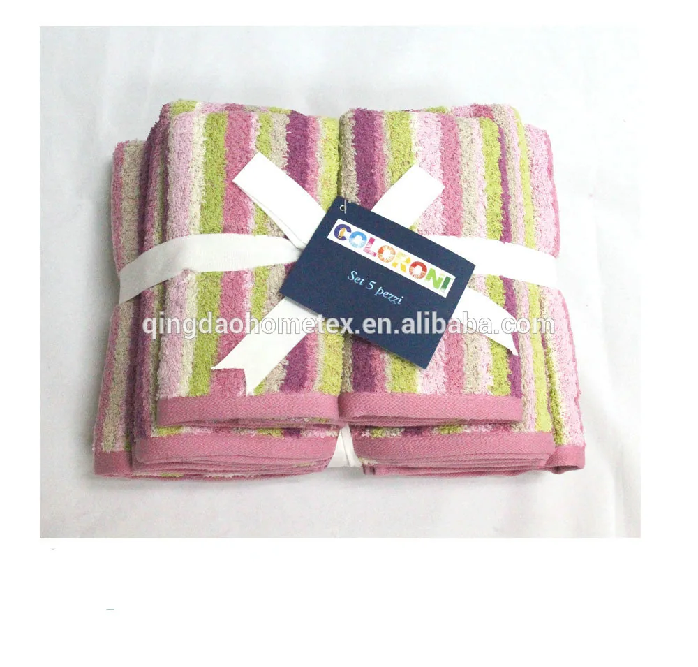 Set of five striped towels in pink, green, and cream, folded and tied with a white ribbon